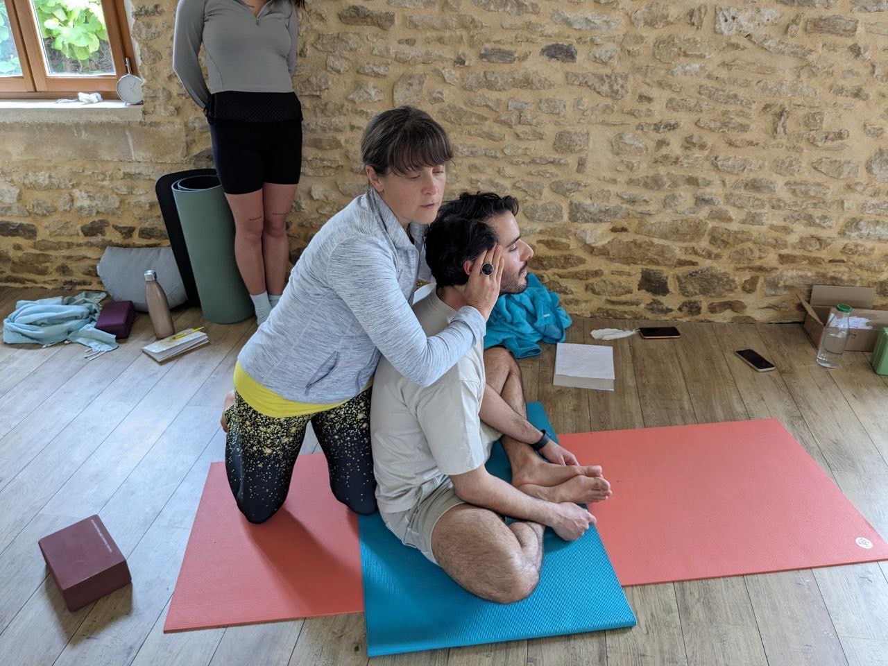 Charlie Speller demonstrating a hands-on yoga assist with Ilias Kousis