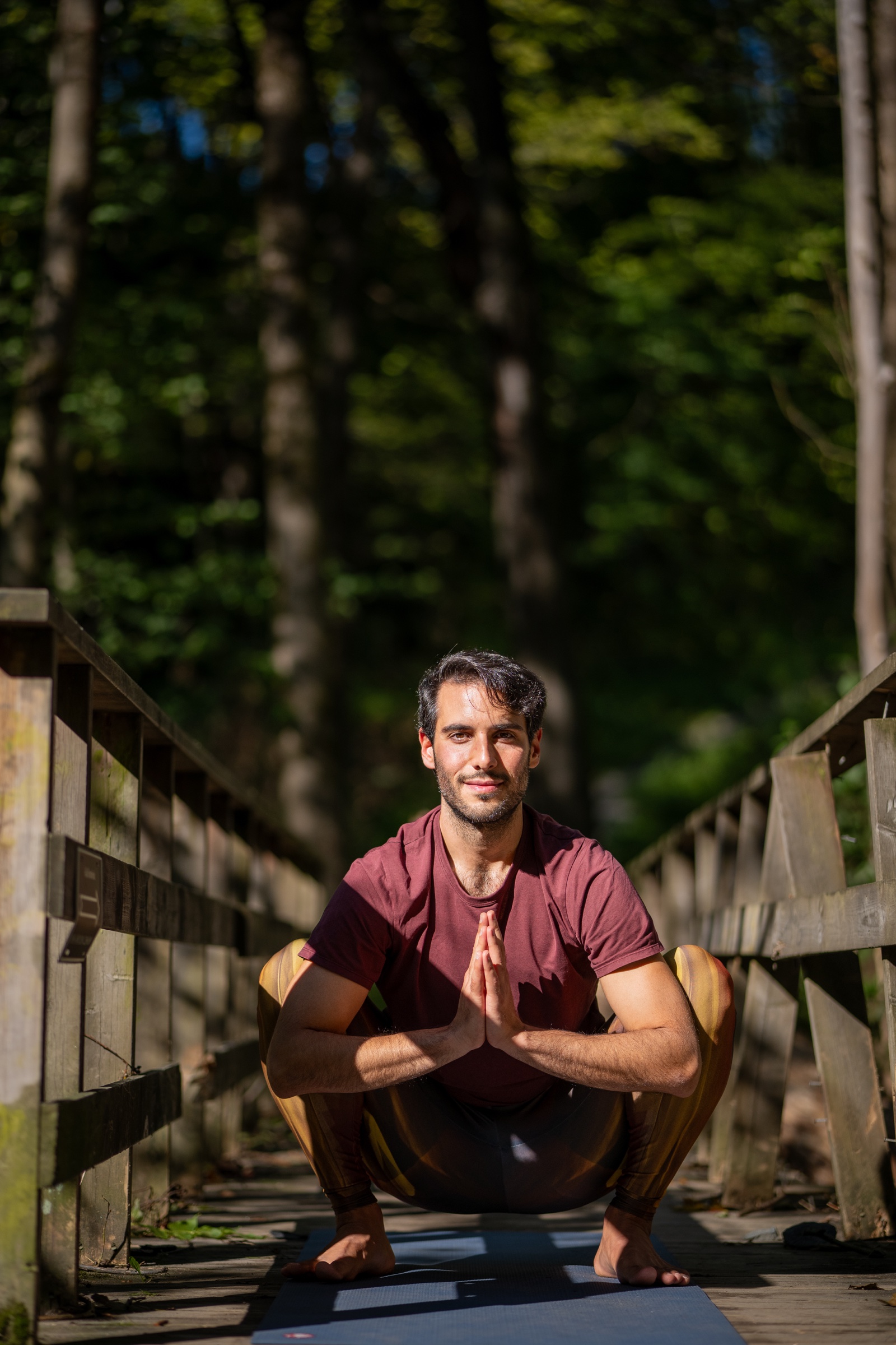 Ilias Kousis seated in a grounded yoga pose outdoors